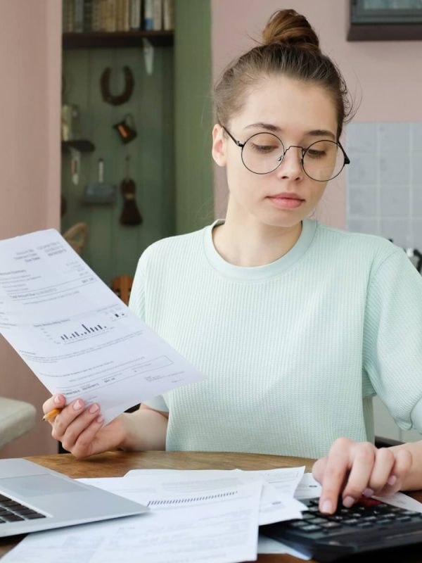 young-beautiful-woman-budgeting-managing-utilities-expenses-writing-financial-plan.jpg