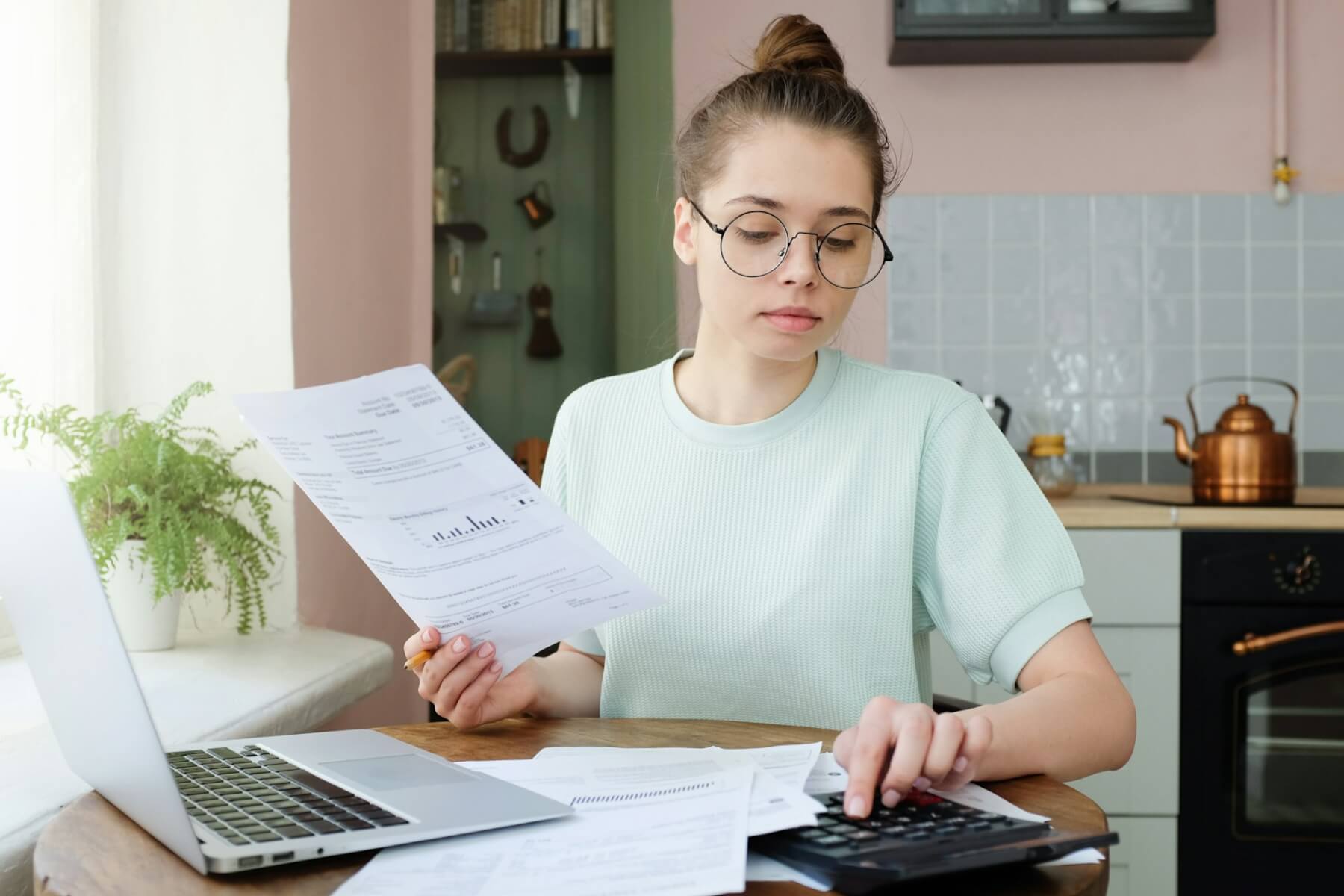 young-beautiful-woman-budgeting-managing-utilities-expenses-writing-financial-plan.jpg